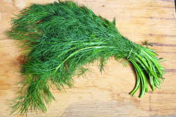 bunch fresh dill herb on wooden table