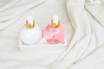 Soap and lotion bottles on a white dressing gown