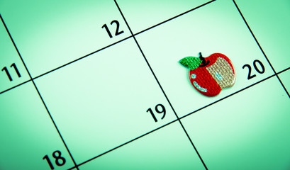 close up of a calendar marked date with sticker