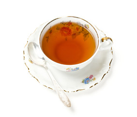 tea in vintage cup isolated on white