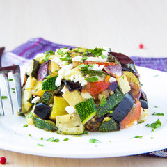 Restaurant appetizer of baked vegetables with feta cheese in gre