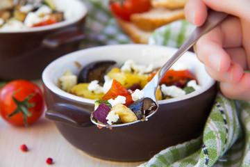 Baked stew of eggplant, zucchini, potatoes and onions with feta