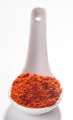 red pepper on white porcelain spoon