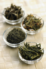 Different sorts of green tea in little bowls