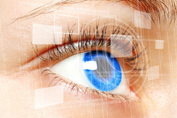 Woman blue eye looking on digital virtual screen close-up.