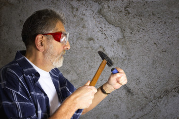Construction worker with hammer and chisel © NatasaAdzic