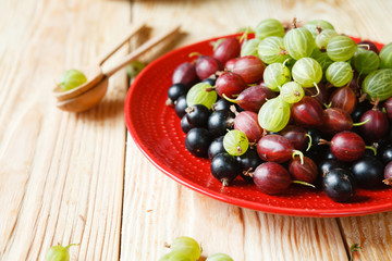 ripe gooseberries and currants on a plate