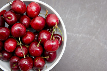 Red cherries in a white bowl
