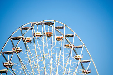 Ferris wheel over the blue sky