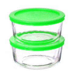 glass food containers with green plastic lids isolated