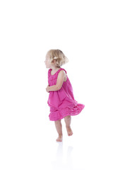 running little girl in pink dress, isolated on white