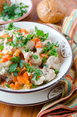 Fototapeta na wymiar Rabbit stew with vegetables and sour cream