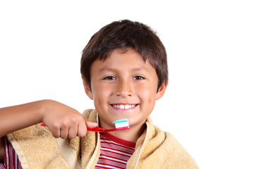 Young boy brushing teeth on white background