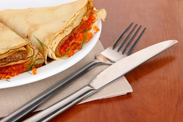 Delicious pancakes with red caviar on table close-up