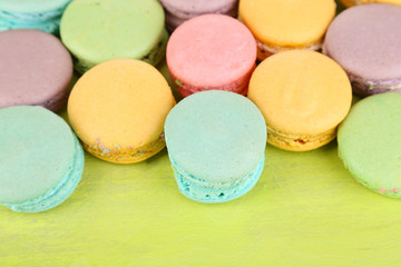 Gentle macaroons on wooden table close-up