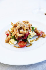 Caesar salad on white plate, close up