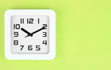 Fototapeta na wymiar Office clock on color wall background