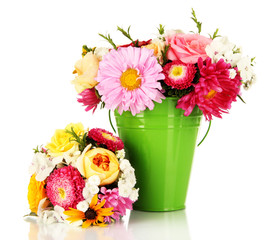 Beautiful bouquet of bright flowers in color vase, isolated