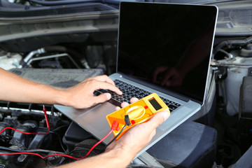 Professional car mechanic working in auto repair service