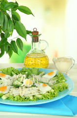 Delicious salad with eggs, cabbage and cucumbers on table