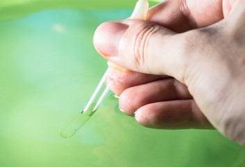 Hand with pipette.