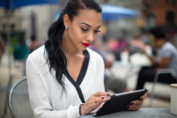 Young beautiful business woman using ipad tablet outdoor - Powered by Adobe