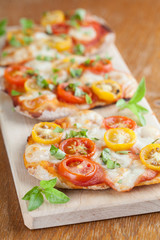 Mini pizzas with mozzarella and cherry tomatoes