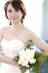 bridge in dress holding bouquet flower in her hands,
