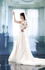Fototapeta premium beautiful smiling girl in a white wedding dress posing