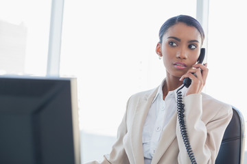 Serious gorgeous businesswoman on the phone