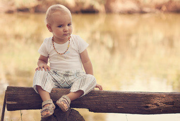 Little girl sitting on the bench