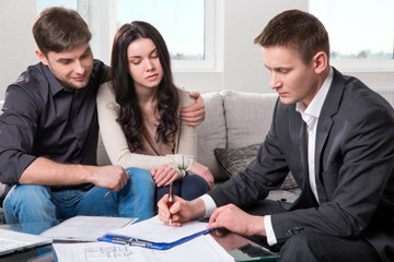 Agent advises the couple, signing documents