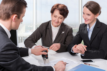 Agent with senior woman and her daughter