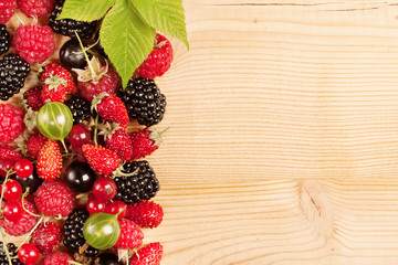 Ripe Berries on Wooden Background
