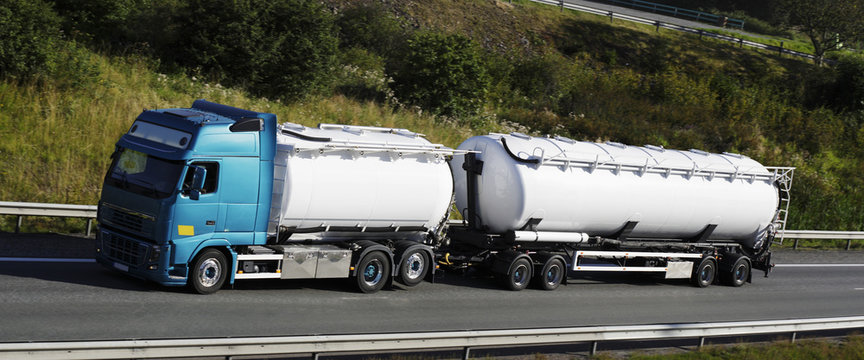 fuel truck driving on highway, panoramic.