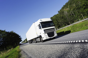 clean white truck driving on freeway.