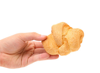 Hand holds striped fresh croissant
