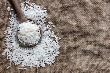 Rice in a wooden spoon and canvas