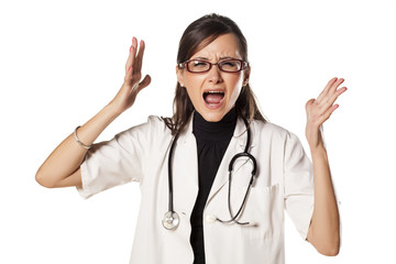 nervous doctor with a stethoscope around her neck yell at you