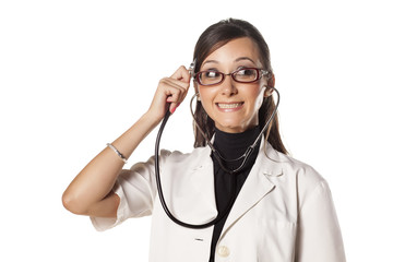 Funny doctor holding a stethoscope  and listens to her thought