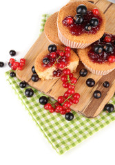 Tasty muffins with berries isolated on white