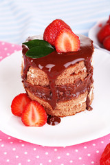 Chocolate cake with strawberry on table close-up