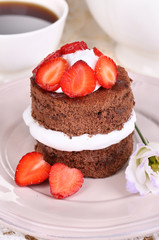 Chocolate cake with strawberry on table close-up