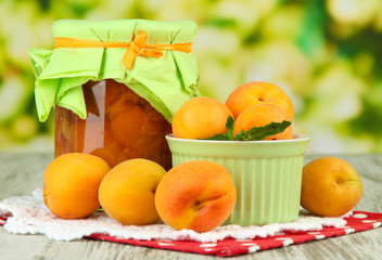 Apricot jam in glass jar and fresh apricots,