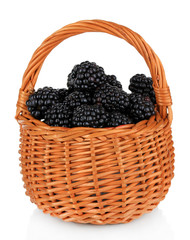 Fototapeta na wymiar Sweet blackberries in wicker basket isolate on white