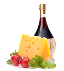 Red wine bottle, cheese and tomato still life