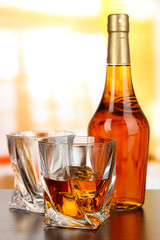 Glass of whiskey with bottle, on dark background