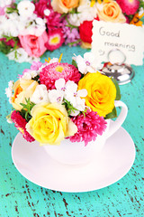 Beautiful bouquet of bright flowers in color vase,