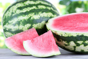 Ripe watermelons on wooden table on nature background