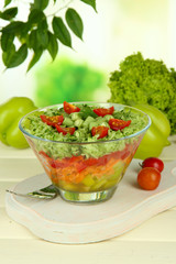 Tasty salad with fresh vegetables on wooden table